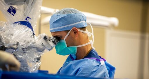 Spine surgeon performs procedure.