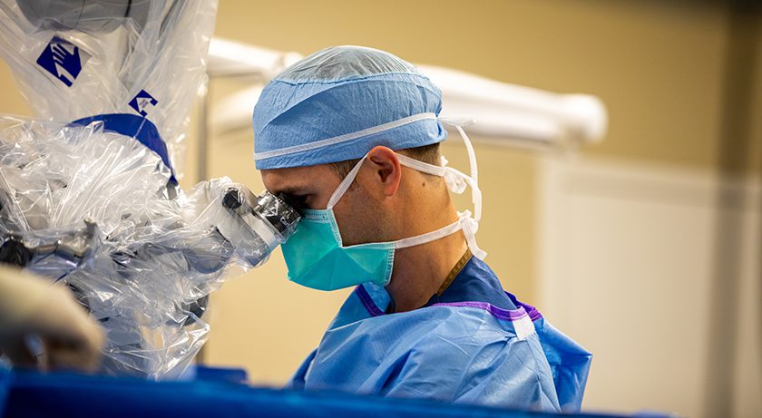 Spine surgeon performs procedure.